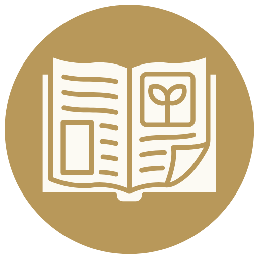 A circular gold icon featuring a white minimalist illustration of an open book or journal with text lines and a small plant sprout on the page.